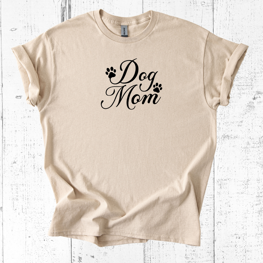 Beige t-shirt with 'Dog Mom' text on a white wooden background