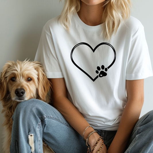 Person wearing a white t-shirt with a heart and paw print design, sitting next to a dog.