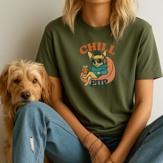 Person wearing a green t-shirt with a dog graphic and 'Chill Pup' text, sitting next to a dog.