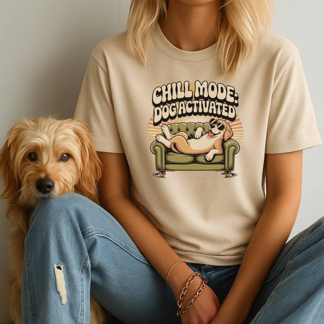 Person wearing a t-shirt with a dog graphic and text, sitting next to a small dog and the phrase Chill Mode: Dog Activated