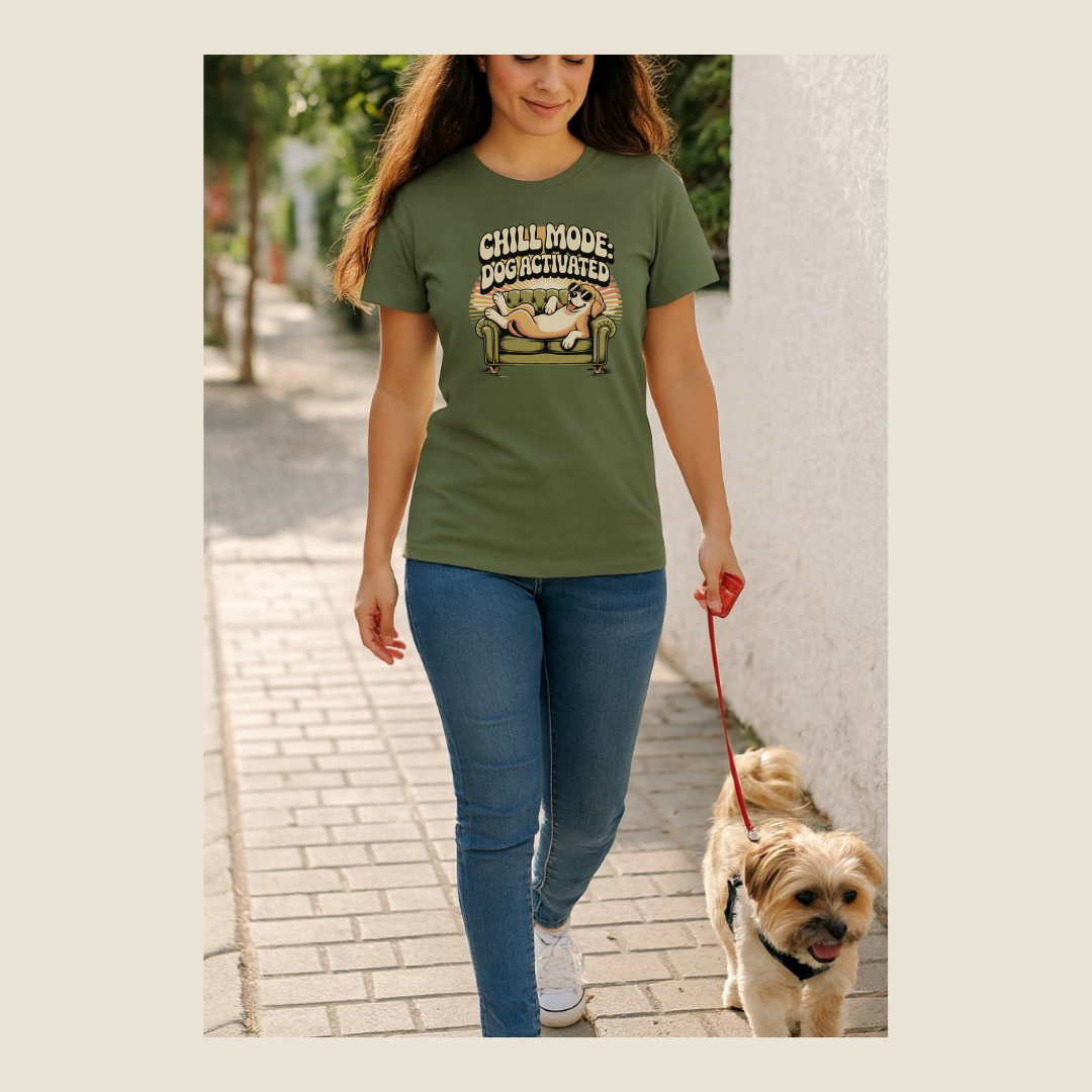 Woman walking a dog on a leash, wearing a green t-shirt with a graphic design and the phrase Chill Mode: Dog Activated