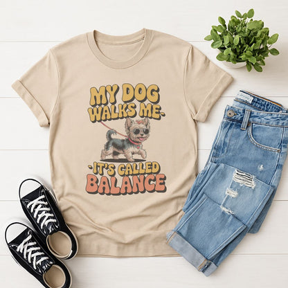 Sand Beige Gildan 6400 unisex t-shirt with retro dog graphic and ‘My Dog Walk Me - It's Called Balance' text, perfect for dog lovers.