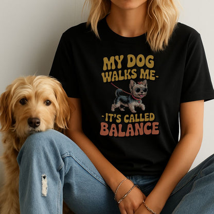 Black unisex t-shirt with retro dog graphic and ‘My Dog Walk Me - It's Called Balance' text, perfect for dog lovers.